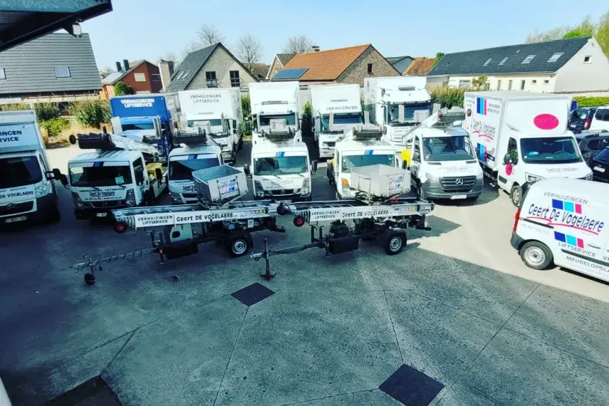 De vloot van De Vogelaere: verhuiswagens, bestelwagens en verhuisliften op het terrein in Deinze